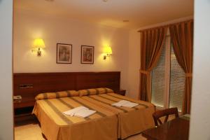 Postel nebo postele na pokoji v ubytování Hotel Tio Felipe