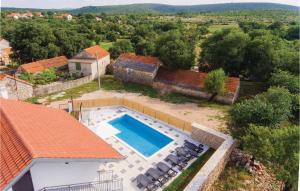 an aerial view of a house with a swimming pool at Three-Bedroom Holiday Home In Unesic in Unešić