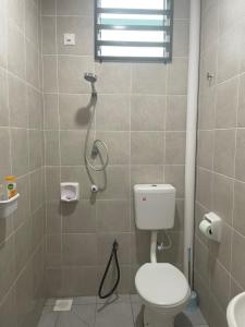 a bathroom with a shower with a toilet and a sink at Mikhail's Homestay in Sungai Petani