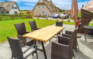 a wooden table and chairs on a patio at Beautiful Home In Groß Schwansee in Groß Schwansee