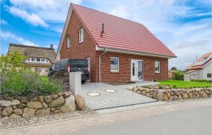 a red brick house with a car parked in the driveway at Beautiful Home In Groß Schwansee in Groß Schwansee