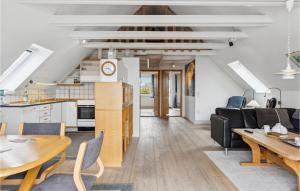 an open kitchen and living room with a table and chairs at Holiday Apartment Skagen 01 in Skagen