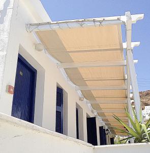 awning on the side of a white building at Drakos Twins in Mylopotas