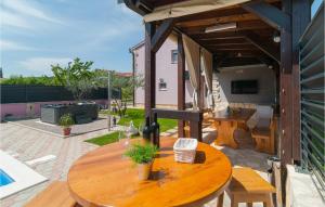 a wooden table sitting on top of a patio at Beautiful Home In Hrvace With Wifi in Hrvace