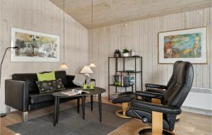a living room with a couch and a table and chairs at Holiday Home Grønningen Børkop Denm in Egeskov