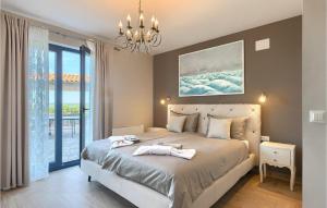 a bedroom with a large bed with a chandelier at Villa Edoardo in Vižinada