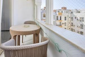 a table and chairs on a balcony with a view at Rare New Marina Hotspot With Fast Free WIFI, Balcony & Pool - Western Standards - Sheraton Plaza 414 in Hurghada