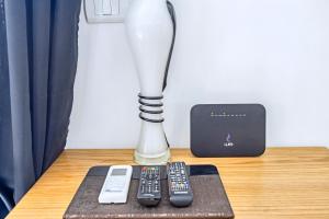 a lamp and two remote controls sitting on a table at Rare New Marina Hotspot With Fast Free WIFI, Balcony & Pool - Western Standards - Sheraton Plaza 414 in Hurghada