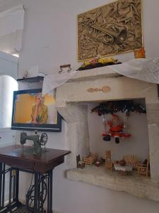 a room with a fireplace with a tv and a table at Eirini's Traditional House in Lístaros