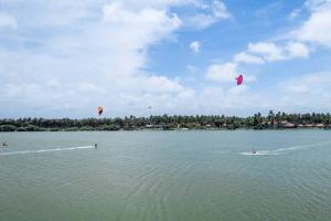 a group of people kite surfing in the water at Bedrock Beach Villas in Kalpitiya
