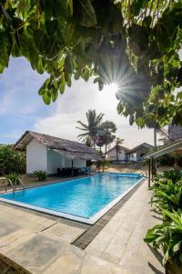 a swimming pool in front of a villa at Bedrock Beach Villas in Kalpitiya