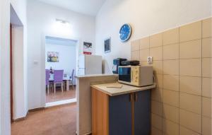 a kitchen with a microwave on top of a counter at Stunning Apartment In Pula With Wifi in Pula +11 photos