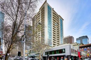 a tall building on a city street with a bus at 222 Stay on Russell Perfect City Getaway in Melbourne