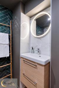 a bathroom with a sink and a mirror at L authentique appartement in Metz