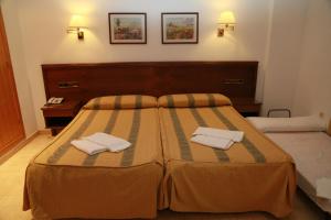 Postel nebo postele na pokoji v ubytování Hotel Tio Felipe