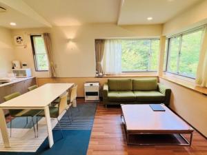 a living room with a couch and a table at Forest Hills Nasu in Nasu