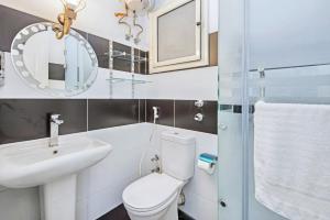 a bathroom with a toilet and a sink and a mirror at Rare New Marina Hotspot With Pool & Fast Free WIFI - Western Standards - Sheraton Plaza 415 in Hurghada