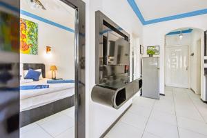 a bedroom with a bed and a television in a room at Rare New Marina Hotspot With Pool & Fast Free WIFI - Western Standards - Sheraton Plaza 415 in Hurghada +37 photos