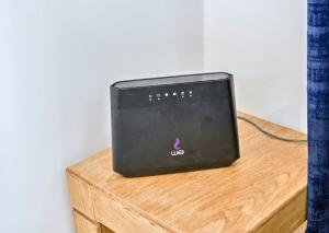 a black device sitting on top of a wooden table at Rare New Marina Hotspot With Pool & Fast Free WIFI - Western Standards - Sheraton Plaza 415 in Hurghada
