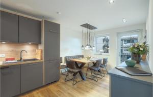 a kitchen and dining room with a table and chairs at 2 Bedroom Cozy Apartment In Nordstrand in Nordstrand +23 photos