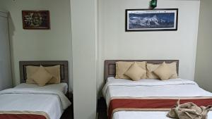 Hotel Pristine客房内的一张或多张床位