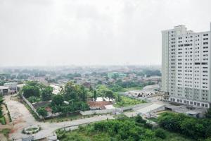 an aerial view of a city with a tall building at New and Simply Studio at Urbantown Serpong Apartment By Travelio in Tangerang