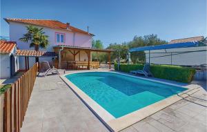 a swimming pool in the backyard of a house at Holiday Home Kraj Croatia in Kraj