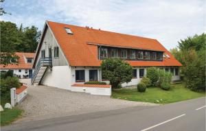 a house with an orange roof on a street at One-Bedroom Apartment In Ebeltoft in Ebeltoft