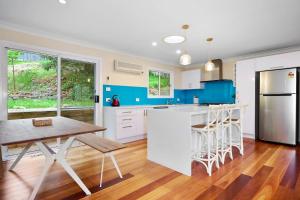 a kitchen with blue and white appliances and a wooden floor at Spacious 3BR Family Haven in Upper Ferntree Gully in Fern Tree Gully +17 photos