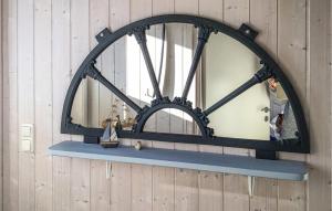 a mirror hanging on a wall with a shelf at Friedrichskoog-Deichblick 4 in Friedrichskoog