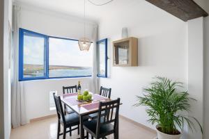 a dining room with a table and chairs at Casa Costa Jameos in Punta de Mujeres +23 photos