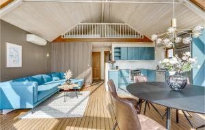 a living room with a blue couch and a table at Two-Bedroom Holiday Home In Hejls in Hejls