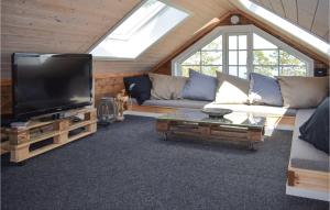 a living room with a large flat screen tv at 5 Bedroom Stunning Home In Passebekk in Omholt