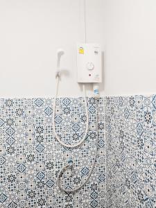 a shower in a bathroom with blue and white tiles at Moochi Relax L'Assommior in Ban Na Song +23 photos