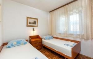 Posteľ alebo postele v izbe v ubytovaní Two-Bedroom Holiday Home In Premantura