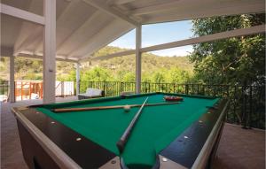 a pool table on a screened in porch with awning at Awesome Home In Skradin With Sauna in Skradin