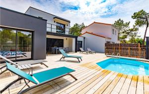 a patio with a swimming pool and a house at Cozy Home In Stjean De Monts in Saint-Jean-de-Monts +20 photos