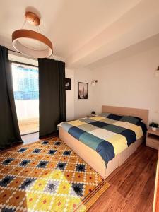 a bedroom with a bed and a rug on the floor at Cozy Apartment with Self Check-in near Promenada Mall and Verdi Park in Bucharest