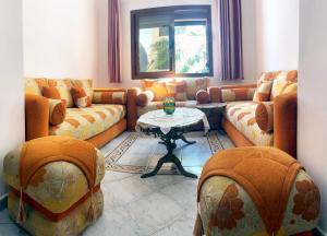 a living room with couches and a table at Beach View Apartment Oued Laou in Oued Laou
