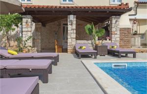 a patio with lounge chairs and a swimming pool at Gorgeous Home In Peruski With Wifi in Peruški