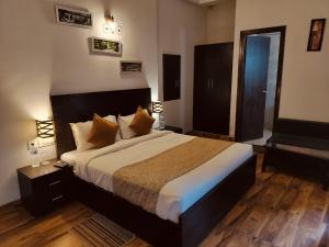 a bedroom with a large bed in a room at Hotel omaxe enternity near by prem mandir in Mathura