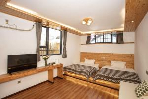 TV a/nebo společenská místnost v ubytování Dali Jishi Hotel