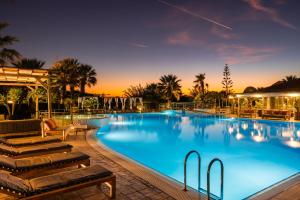 a large swimming pool at night with a resort at Avithos Resort Hotel in Svoronata