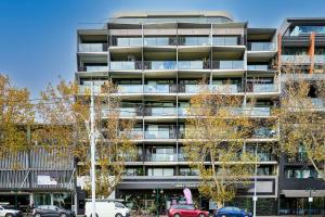 un immeuble d'appartements avec des voitures garées devant dans l'établissement Stylish 1 Bedroom Retreat in St Kilda w Car Park, à Melbourne 5 autres photos