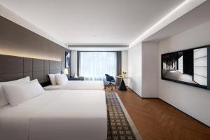 Postel nebo postele na pokoji v ubytování Intercity Hotel Chengdu High-tech Global Center