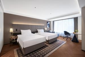Postelja oz. postelje v sobi nastanitve Intercity Hotel Chengdu High-tech Global Center