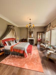 a bedroom with a bed and a living room at Chateau d'Urspelt in Urspelt