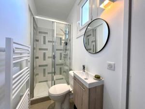 a bathroom with a toilet and a sink and a mirror at Studio lumineux à 100m de la plage ! in Saint-Jean-de-Luz