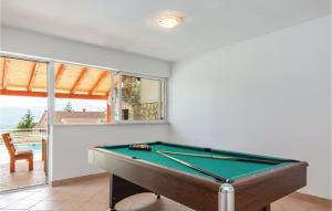 a pool table in a room with a view of the ocean at Holiday Home Imotski 04 in Imotski