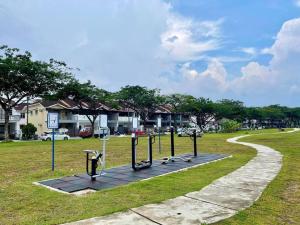 a park with a group of equipment in the grass at Lovely Modern Home 4 Bedroom Mount Austin JB in Johor Bahru